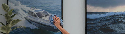 A hand cleaning a Techlite acoustic frame surface with a blue cloth.